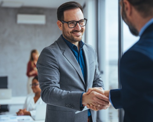 advisor shaking hands with business client